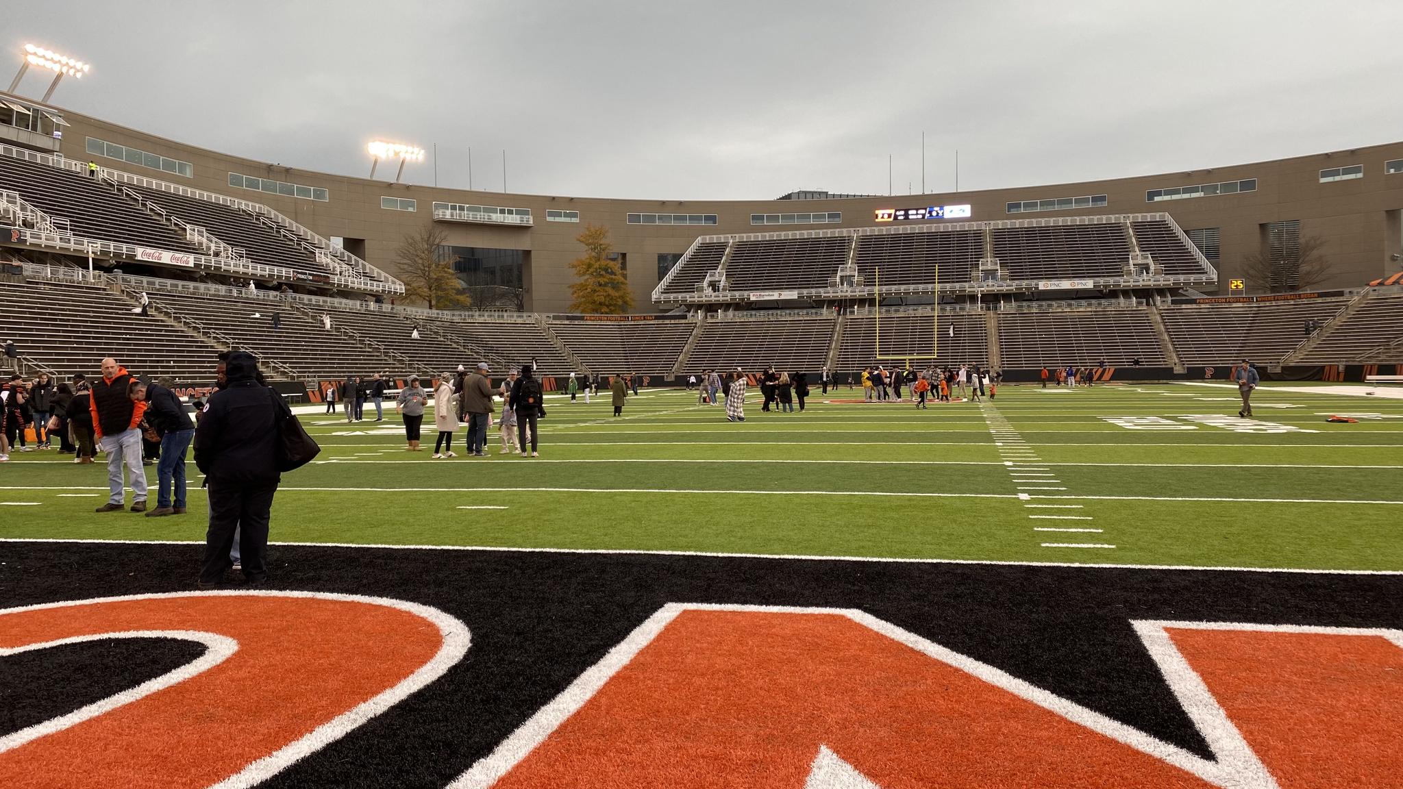 A photo of fans on the field at Princeton Stadium after a game