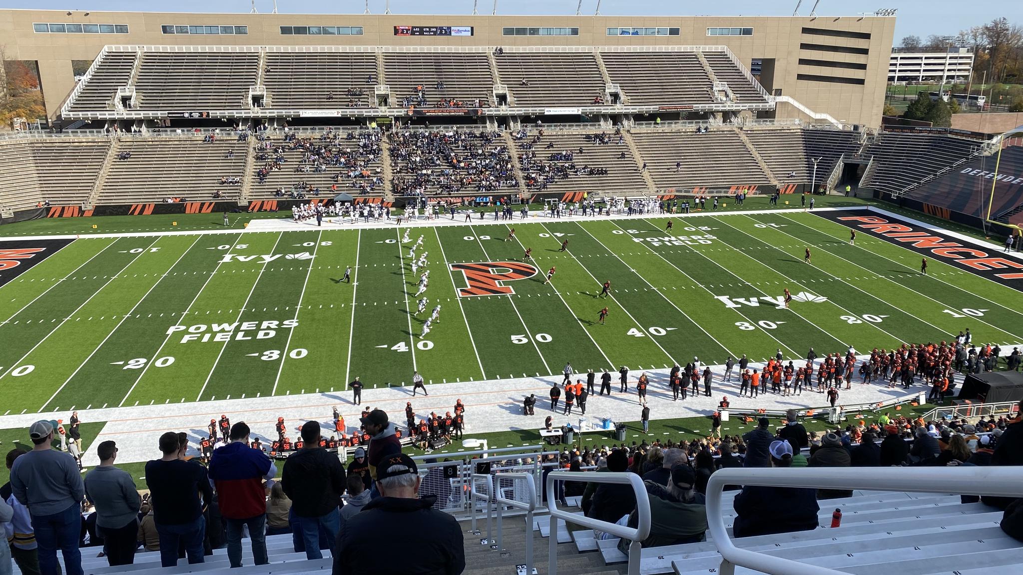 An image of a play during a football game taken from the last row of the stadium