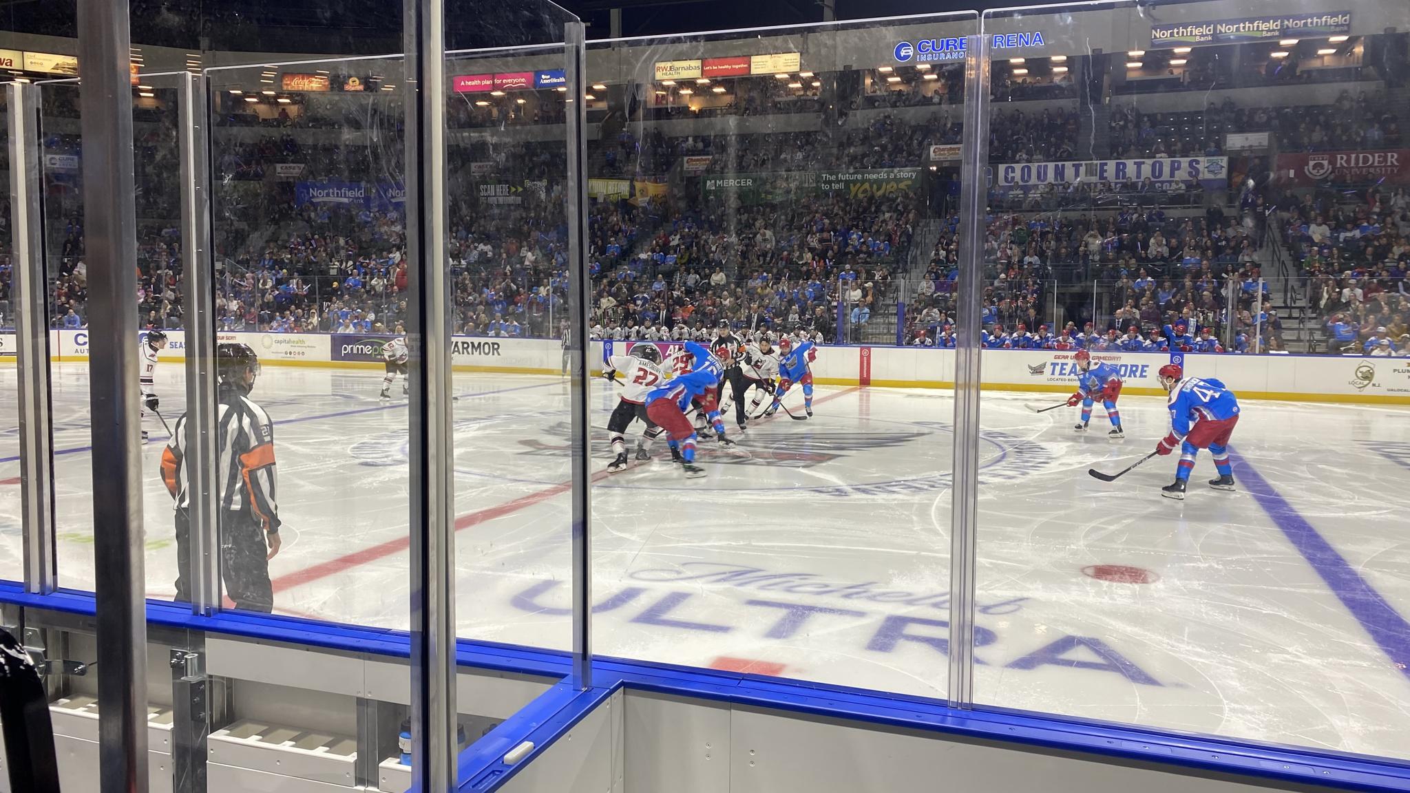 An image of the opening faceoff of a hockey game